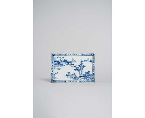 A CHINESE BLUE AND WHITE RECTANGULAR TILE KANGXI 1662-1722One side painted with a lone fisherman on a rocky ledge beside a la
