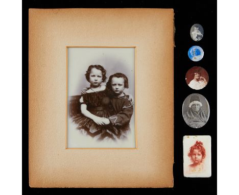 Group of six antique enamel covered, tin, and milk glass photographs depicting portraits. The largest depicting two young chi