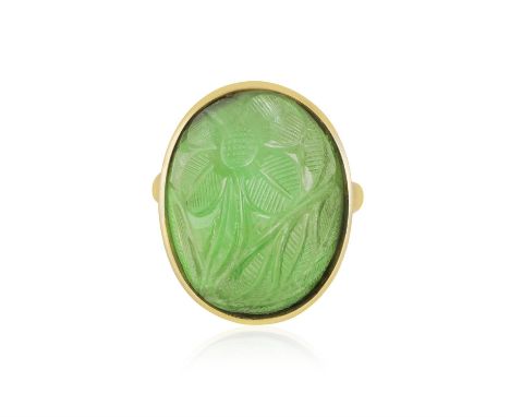AN EMERALD RINGOf foliate design, the oval-shaped carved cabochon emerald weighing approximately 30.00cts within collet-setti
