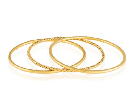 THREE GOLD BANGLESComposed of two polished gold bangles, in 18K gold, with maker's mark 'Sté HL' and French assay marks, inne