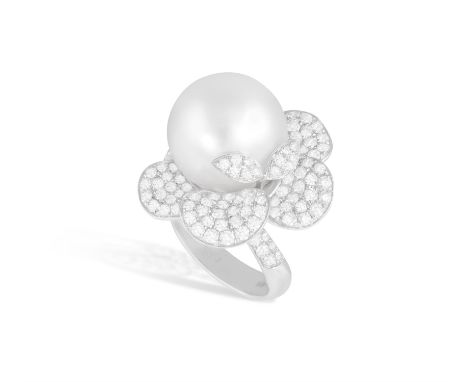 A CULTURED PEARL AND DIAMOND DRESS RINGOf flowerhead design, centring a cultured South Sea pearl measuring approximately 14.7