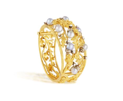 A CULTURED PEARL AND DIAMOND BANGLE, ITALIAN, CIRCA 1960Of openwork foliate design throughout, the frontispiece embellished w
