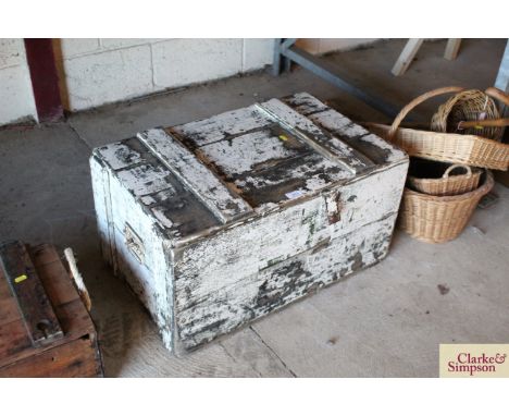 A painted pine trunk with metal hasp and a side carrying handle