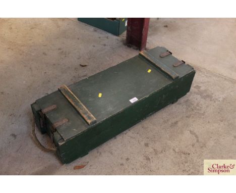 A green painted wooden trunk with rope carrying handles