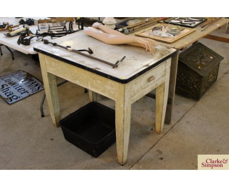 A small painted pine and enamel topped kitchen table with fitted end drawer
