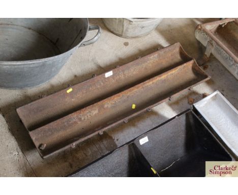 A cast iron two section trough