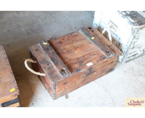 A vintage pine bomb box with enamel instruction panel