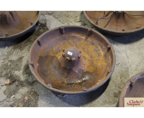 A circular iron pig trough