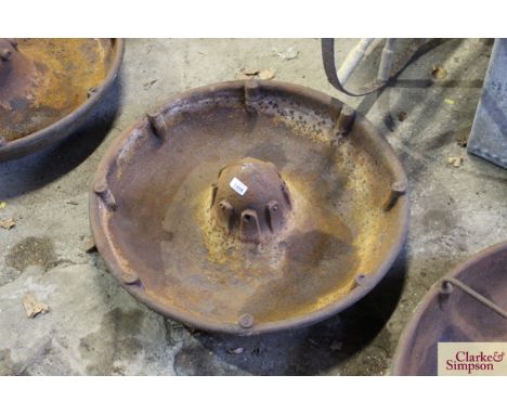 A circular iron pig trough