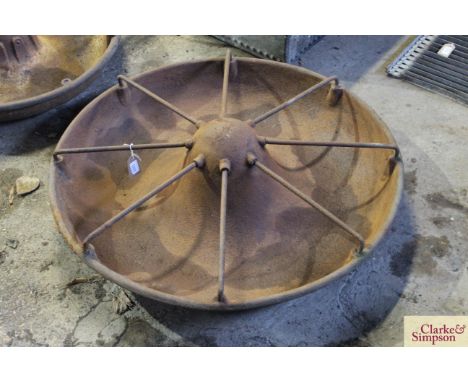 A circular iron pig trough complete with division bars 