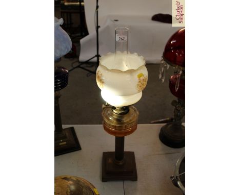 A brass Corinthian column table oil lamp with clear glass reservoir and floral shade 