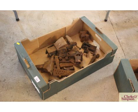 A tray box and contents to include miniature cast iron anvil, bench vices, iron wedges etc.
