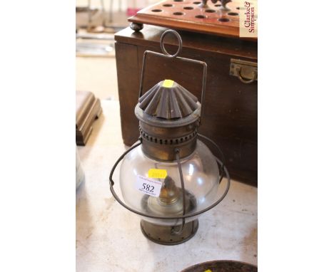 A hanging brass oil lamp