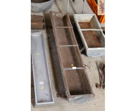 A metal four division pig trough