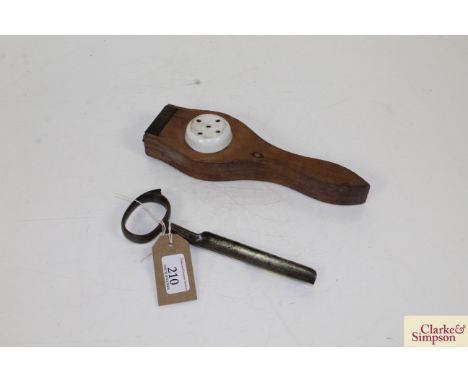 An early 20th Century treen and ceramic lever type lemon squeezer, and a late 19th Century steel cheese tester - vendor repor