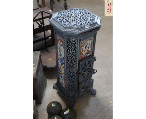 An Art Nouveau style cast iron and enamel multifuel stove inscribed "Godin"