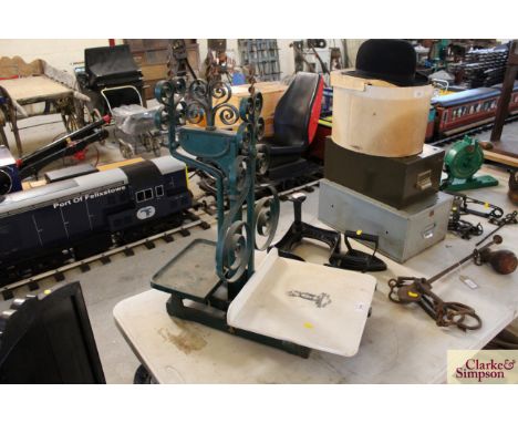 A set of vintage iron shop scales with decorated ceramic plate