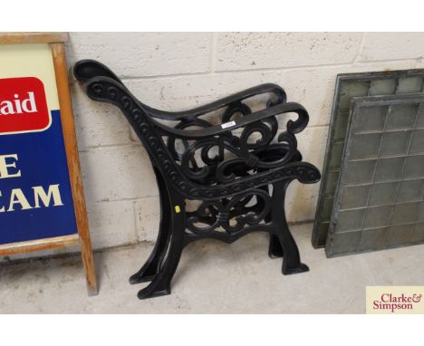 A pair of black cast iron bench ends
