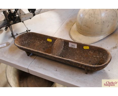 A small cast iron two section trough