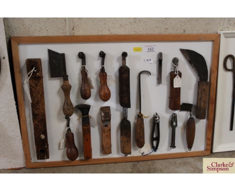 A display board of a drag knife, wooden bench hook, glazing iron, fudge wheels, punches etc.