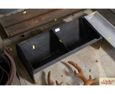 A cast iron two section trough