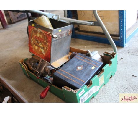 A tray box with contents to include a vintage biscuit tin, a Victorian ebonised and walnut banded trinket box, a mincer etc.