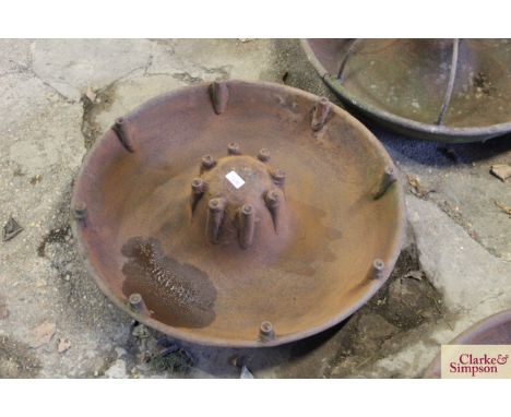 A circular iron pig trough