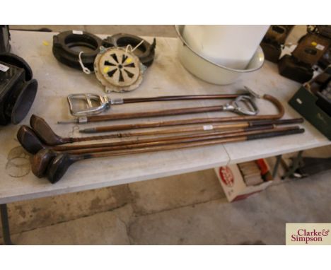 Four wooden shafted vintage golf clubs one by Robert Forgan, two shooting sticks and a walking stick