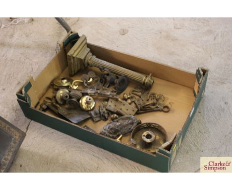 A tray box and contents of various brass and other metalware to include a Corinthian column table lamp base, a chamber stick,