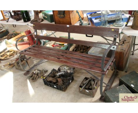 A wooden slatted and iron garden bench