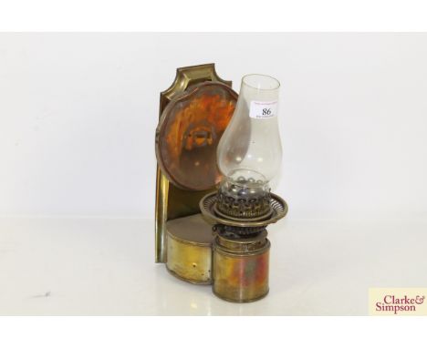An antique copper and brass wall mounting oil lamp