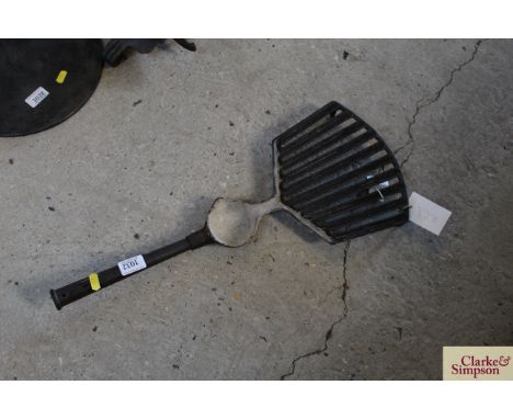 An iron and enamel grid iron with reservoir by Kenrick &amp; Sons