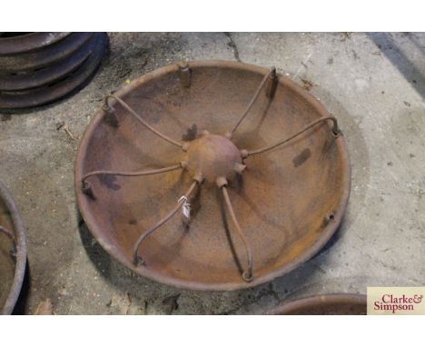 A circular iron pig trough