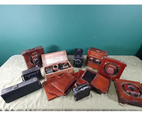 Two Thornton Pickard mahogany and brass folding plate Cameras, 'The National Camera' mahogany folding plate Camera, another l