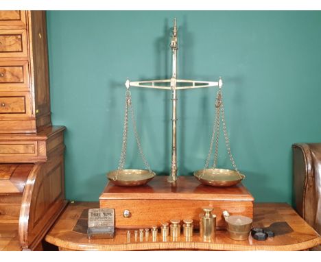 A large set of Avery brass and mahogany gold Balance Scales, the base fitted drawer and with a quantity of brass troy weights