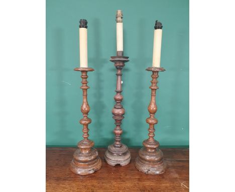 A pair of walnut Table Lamps with baluster turned stems on circular bases, fitted electricity, and a similar single lamp, app
