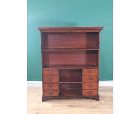 A late Victorian mahogany small Bookcase with open shelves above two banks of four drawers flanking another shelf, 3ft 9in H 