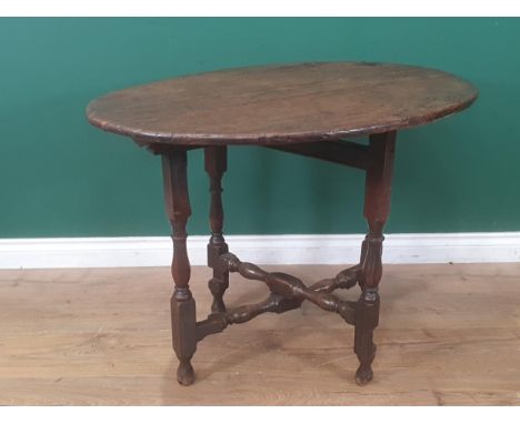 A late 17th Century Coaching Table with elm oval top raised upon oak baluster and squared supports 3ft W x 2ft 2in H 