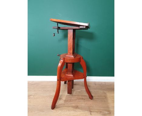 A late 19th Century mahogany Studio Camera stand, a rise, fall and tilting mechanism on shaped supports 
