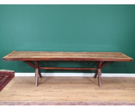 An antique oak long Tavern Table with thick three-plank cleated top on cross frame supports with connecting stretcher, 9ft 11