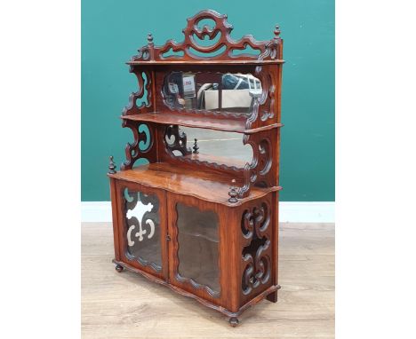 A Victorian walnut Table Cabinet with mirror panels to the raised shelves and glass panels to the pair of cupboard doors and 