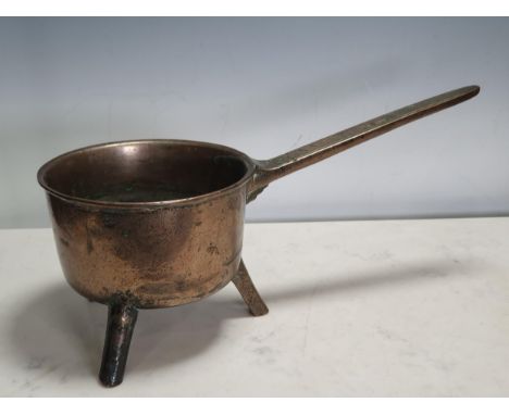 An antique bell metal Skillet, the handle inscribed 'Warner' on three peg supports, 16in, including handle 