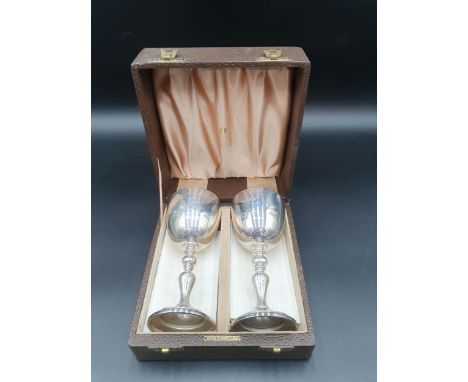 A pair of Elizabeth II silver Limited Edition Silver Wedding Goblets on baluster columns decorated fruiting vines, London 197