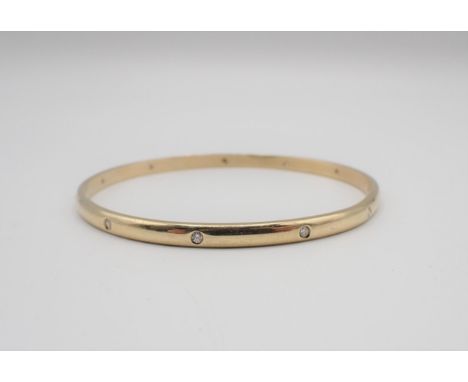A Diamond Bangle gypsy-set eleven brilliant-cut stones in gold, unmarked, untested, approx 20gms 
