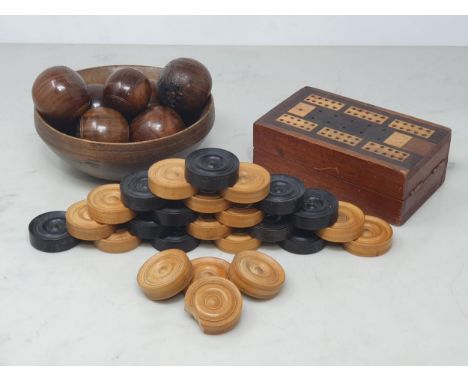 A part set of lignum vitae miniature Carpet Bowls, a turned treen Bowl bearing initials 'L&amp;R', an incomplete treen Draugh