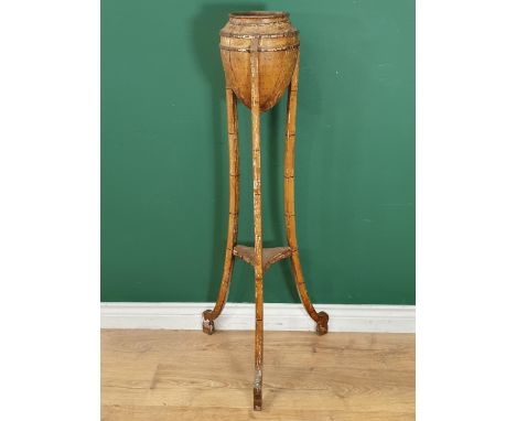 A 19th Century painted faux bamboo two tier Plant Stand the top in the form of an Acorn, raised on slender tripod supports, 3