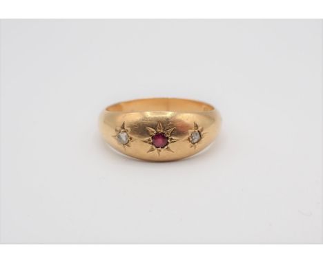 A Ruby and Diamond Ring gypsy-set round ruby between two rose-cut diamonds in 18ct gold, ring size R. approx 3.45gms 