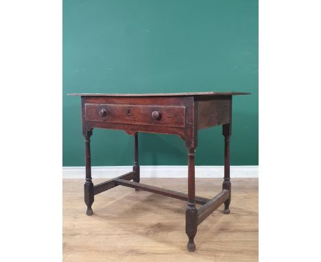 An 18th Century oak Side Table with three piece top, single fitted drawer, above a shaped frieze, on shaped and turned suppor