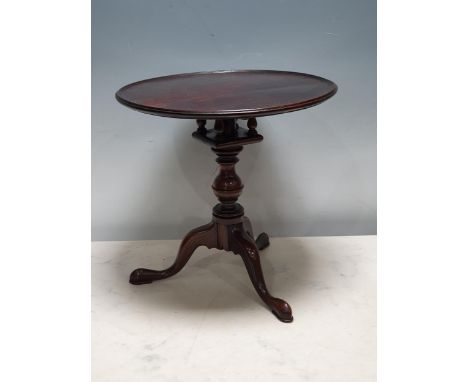 An apprentice piece mahogany Tripod Table with dished top on bird cage support and baluster column, 9 1/2in H 
