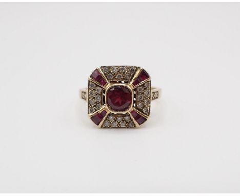 An Art Deco style square Cluster Ring set central round garnet within pavé-set brilliant-cut diamonds and tapered ruby baguet